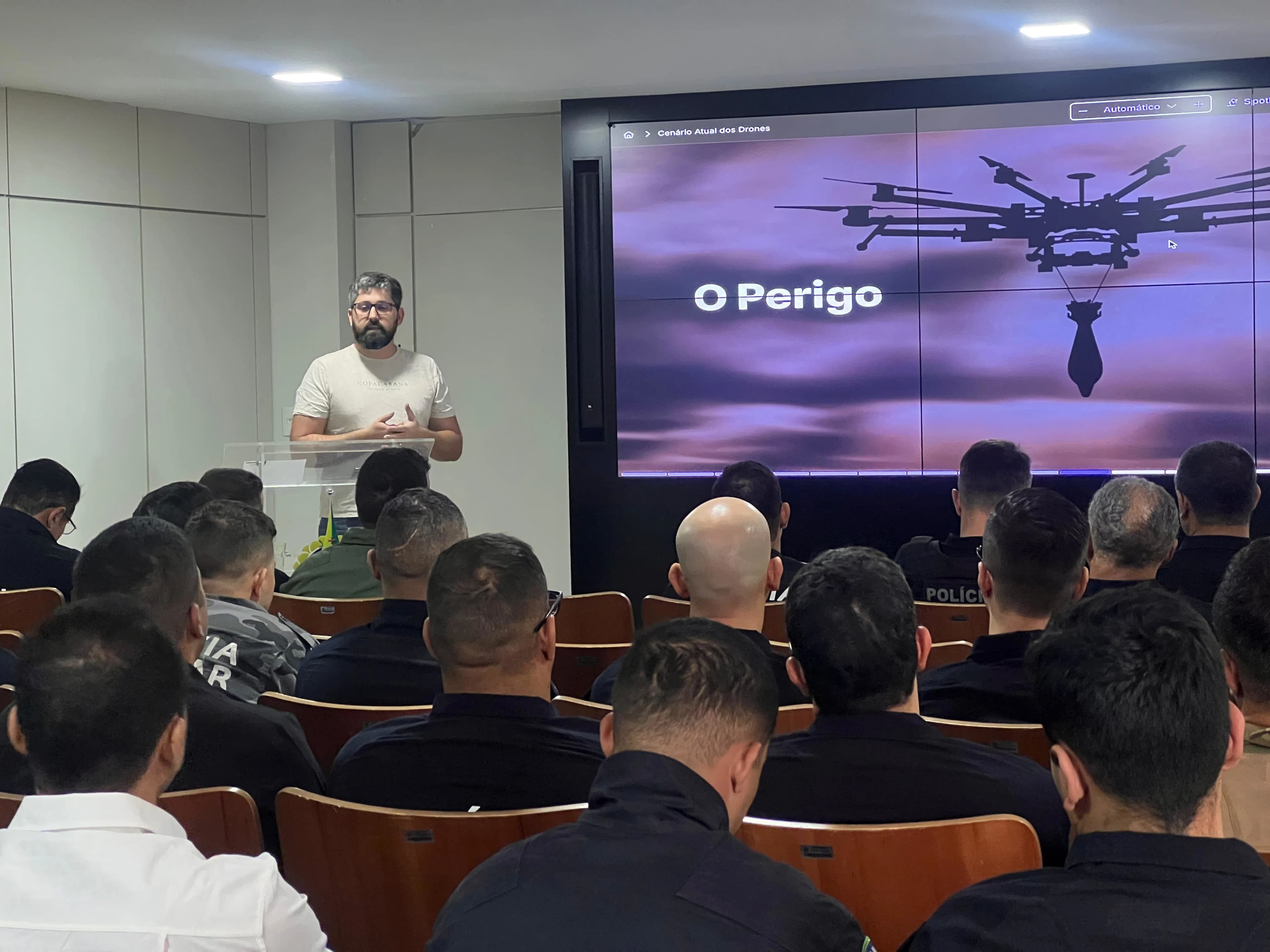 A person learning to fly a drone in an open field.